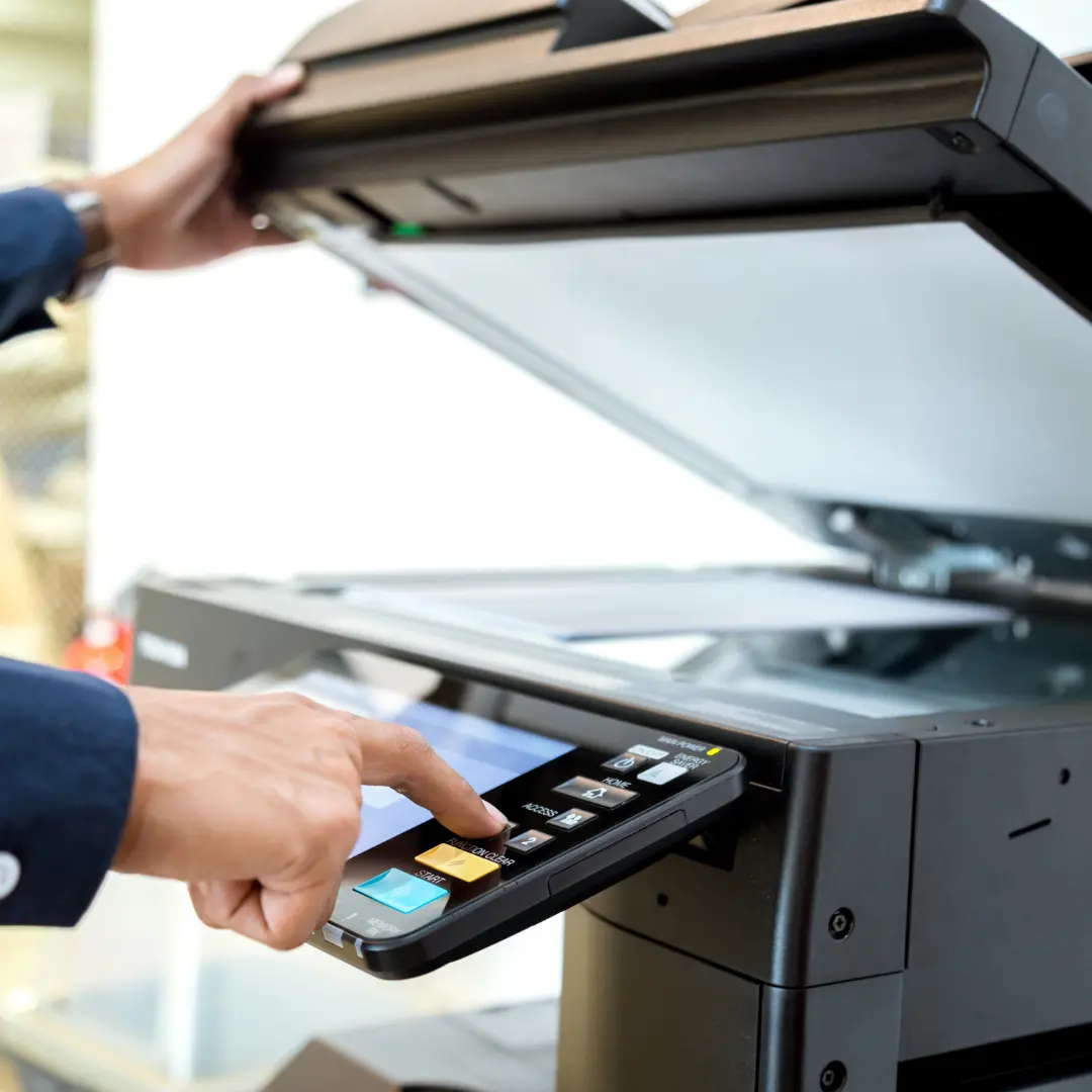 user at multi function printer photocopying a document